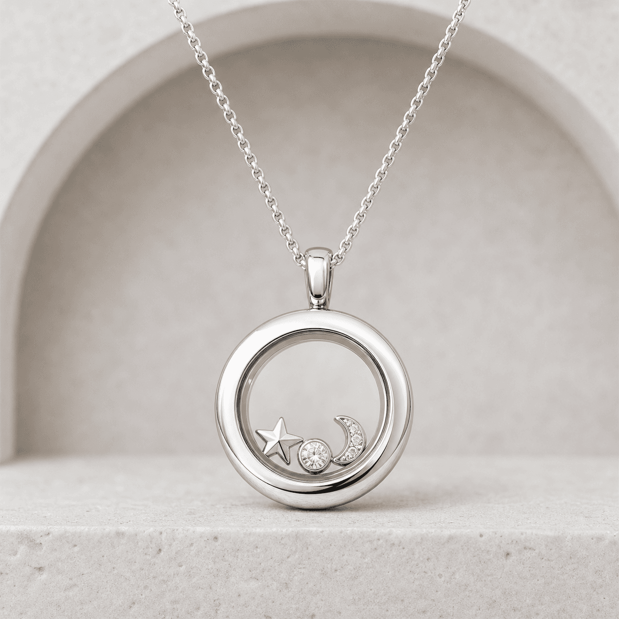 Preview image of a round silver-colored locket with celestial charms