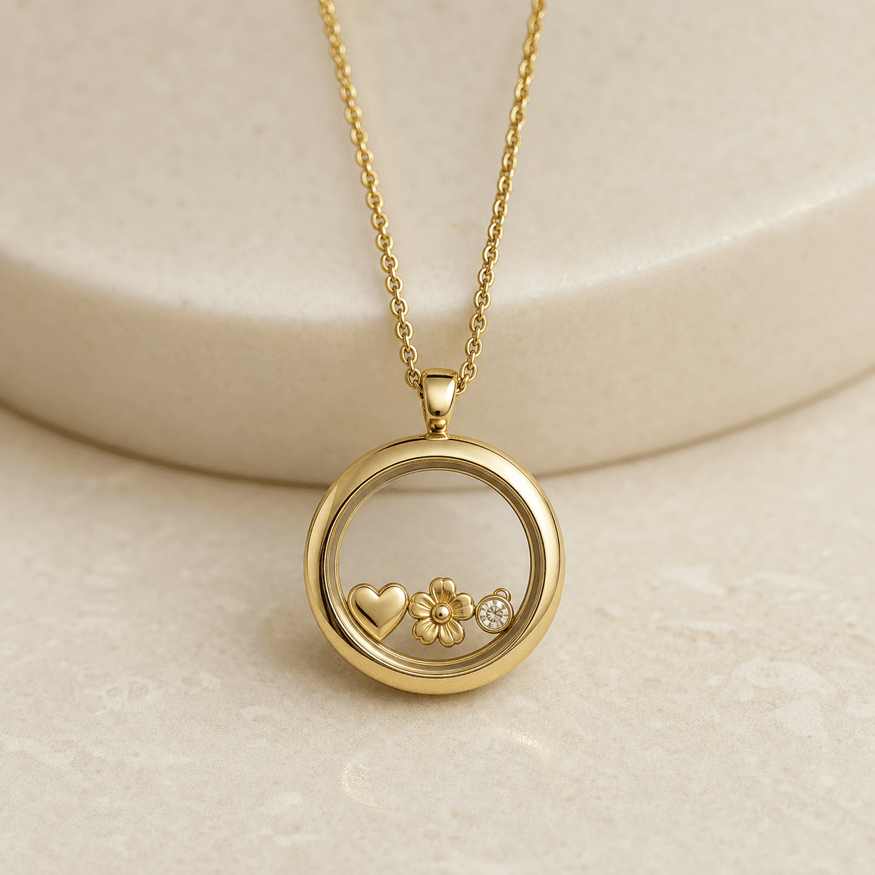 Preview image of a round gold-colored locket with small decorative charms