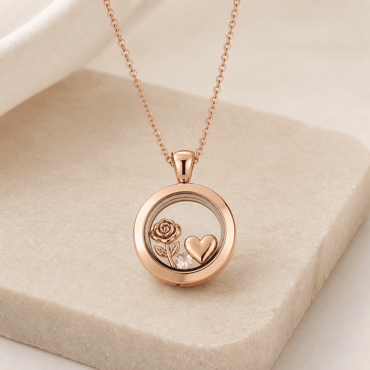 Preview image of a round rose-colored locket with small decorative charms